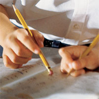 students writing together in workbook
